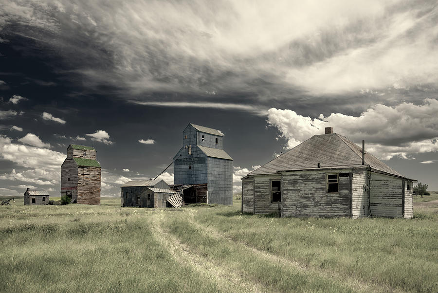 Charbonneau ND Series - Ghost town grain elevators and post office building Photograph by Peter Herman