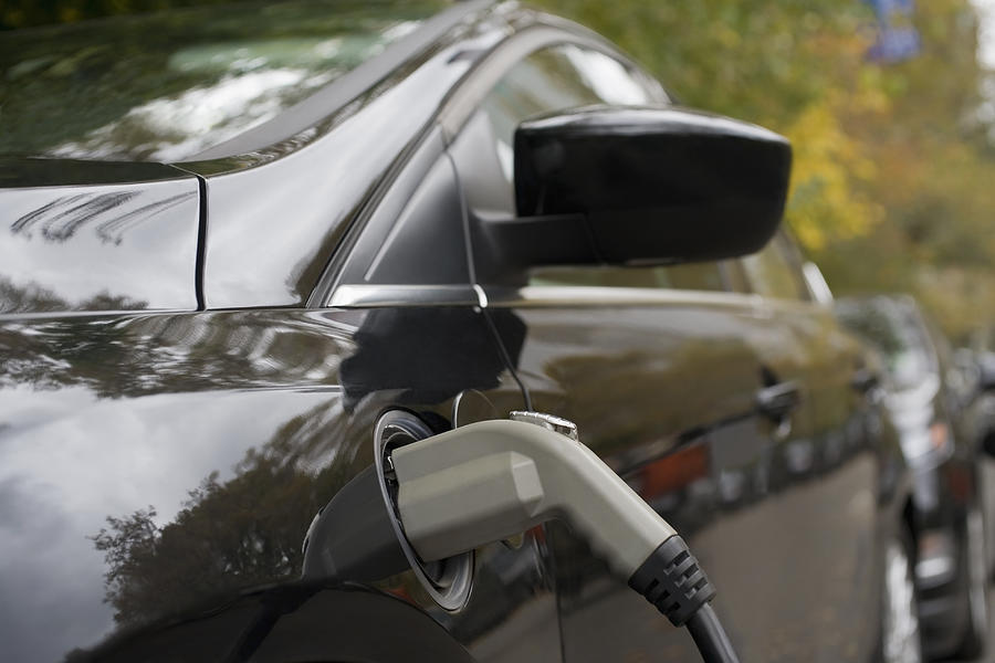 Charging an electric car, close-up Photograph by REB Images