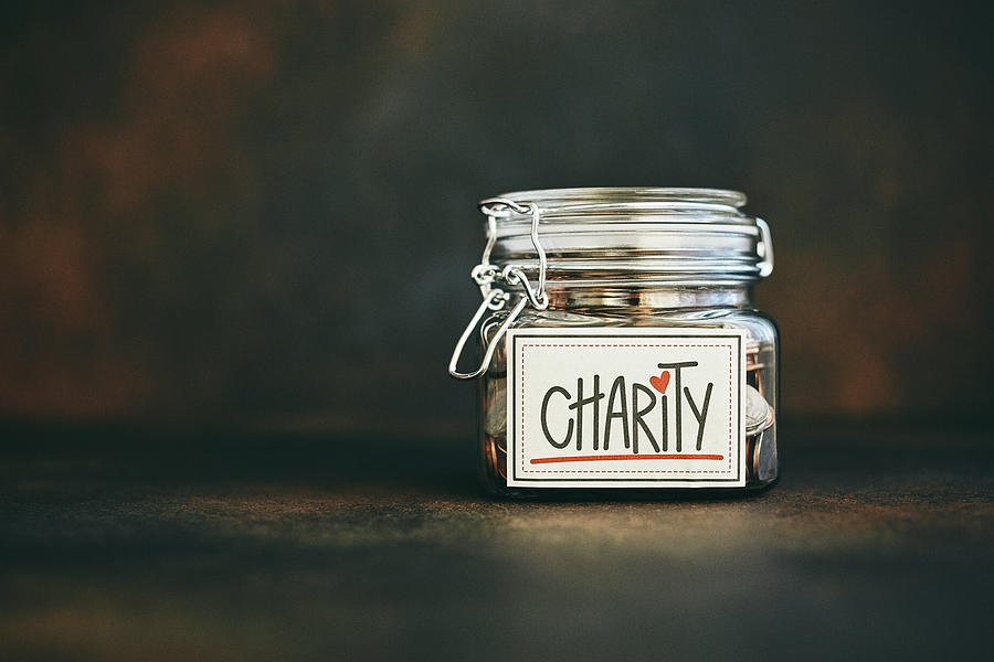 Charity jar filled with money Photograph by CatLane