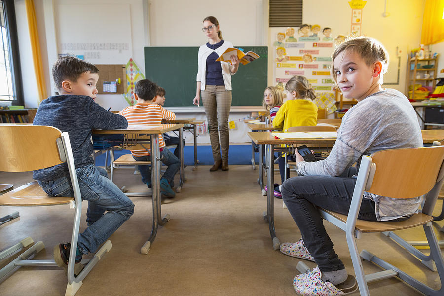 Cheating Schoolkid In A Classroom Photograph by Matthias Tunger