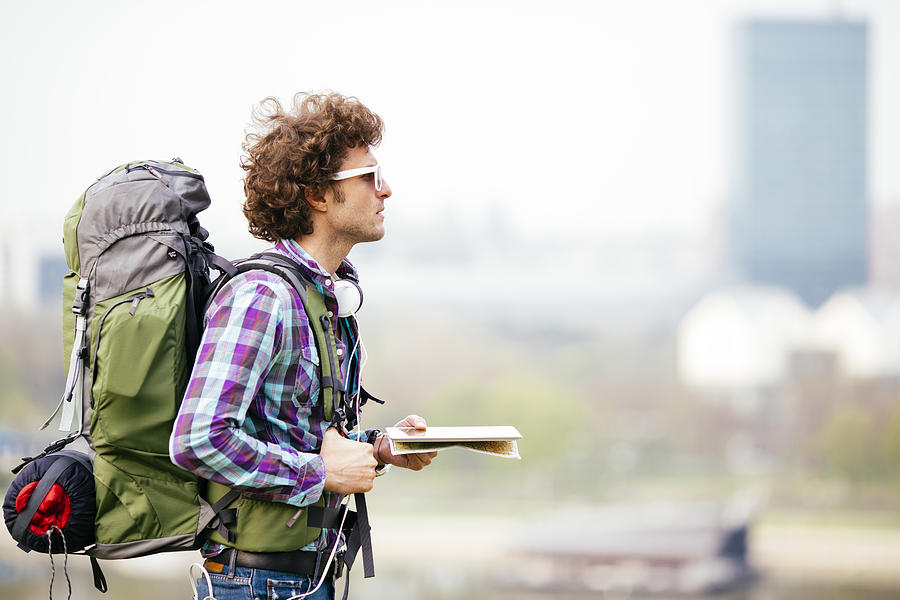 Cheerful Backpacker Holding Map. Photograph by Vgajic