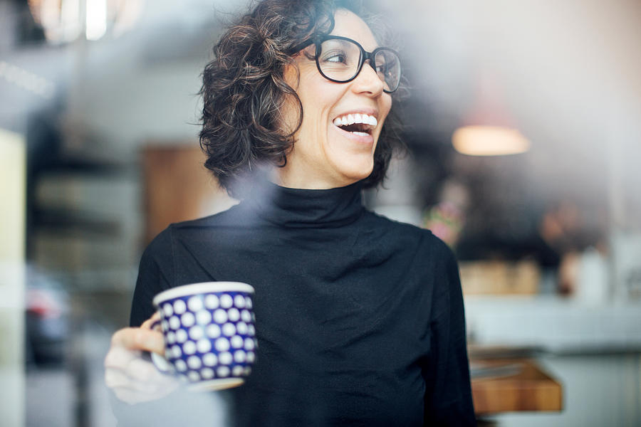 Cheerful businesswoman at coffee shop Photograph by Luis Alvarez