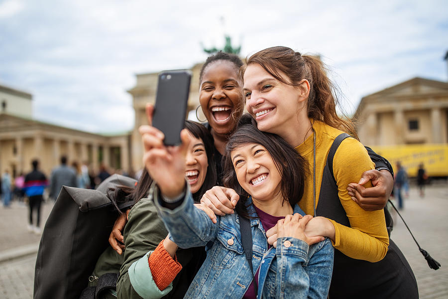 Cheerful friends taking selfie against Brandenburg Gate Photograph by Luis Alvarez