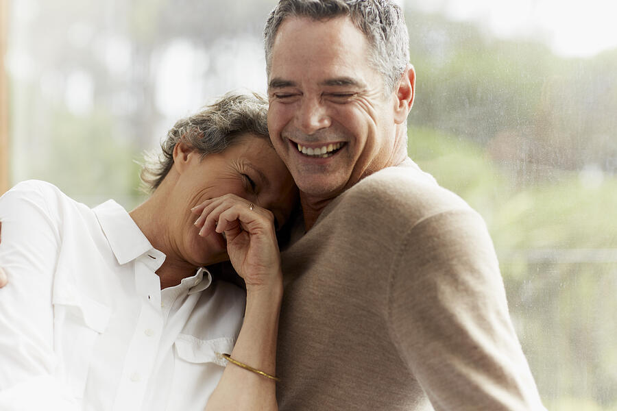 Cheerful mature couple at home Photograph by Morsa Images