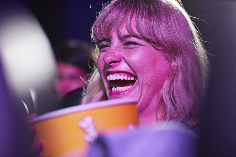 Cheerful woman enjoying at movie theater Photograph by Klaus Vedfelt