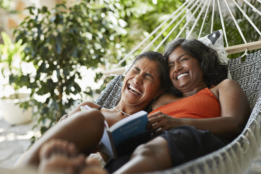 Cheerful woman lying with mother in hammock Photograph by Klaus Vedfelt Cheerful woman lying with mother in hammock Photograph by Klaus Vedfelt