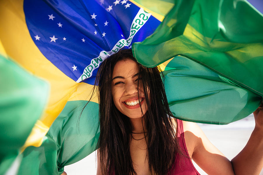 Cheering woman under brazilian flag Photograph by Wundervisuals