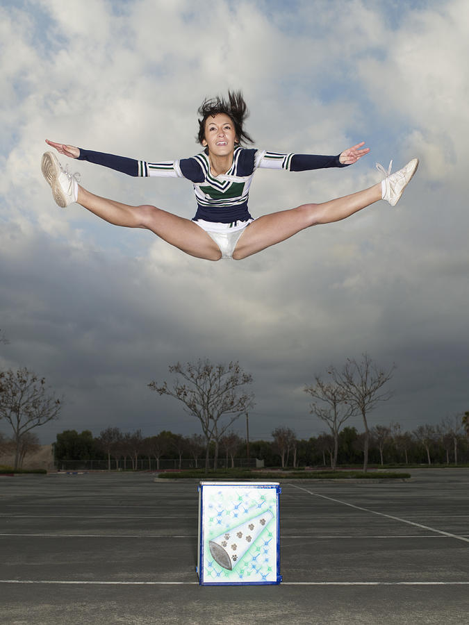 Cheerleader jumping off box Photograph by Tony Anderson