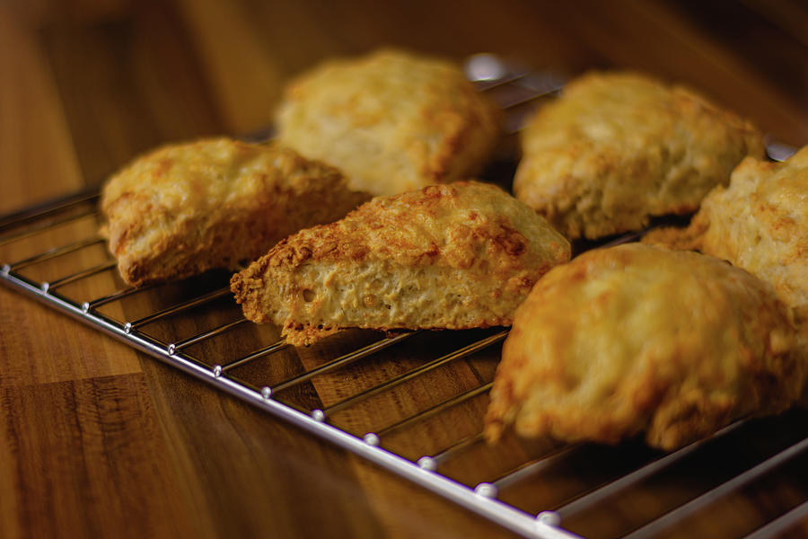 Cheese scones on a cooling rack Photograph by Scott Lyons
