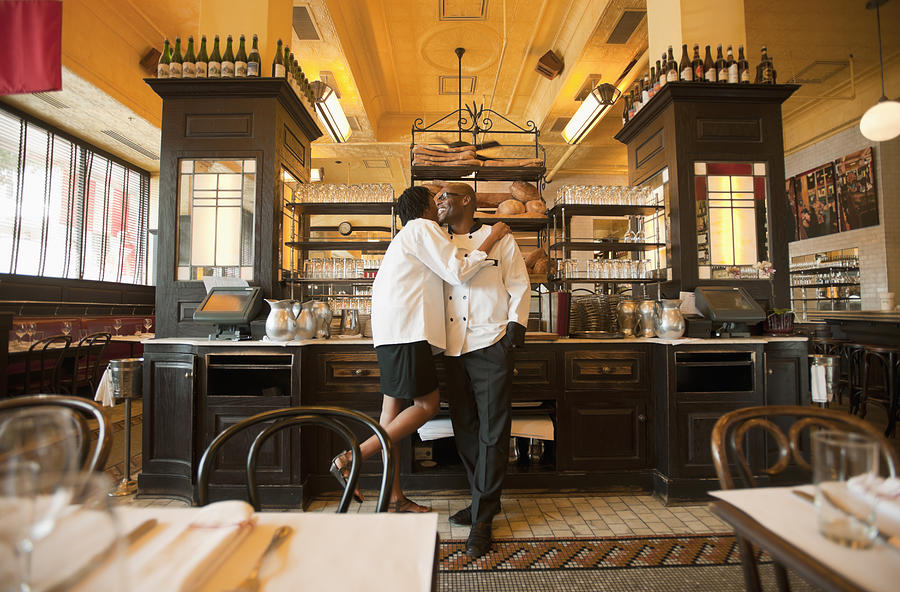 Chef and waitress hugging in restaurant Photograph by Mark Edward Atkinson/Tracey Lee