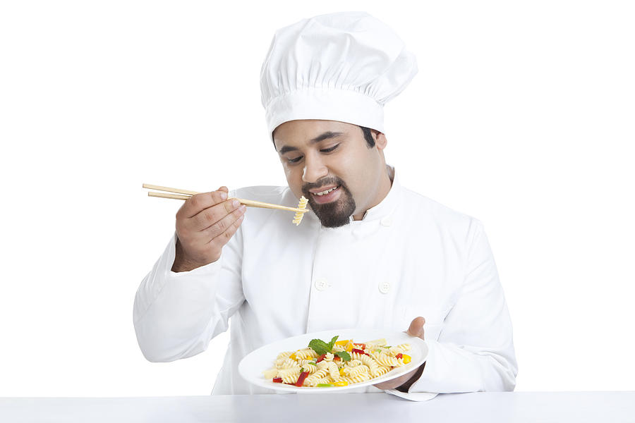 Chef eating pasta with chopsticks Photograph by IndiaPix/IndiaPicture