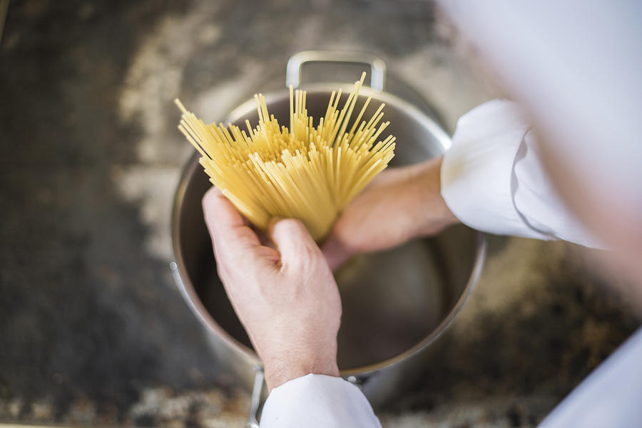 Chef putting pasta in the pot. Rzeszow, Poland Photograph by Anna Bizon