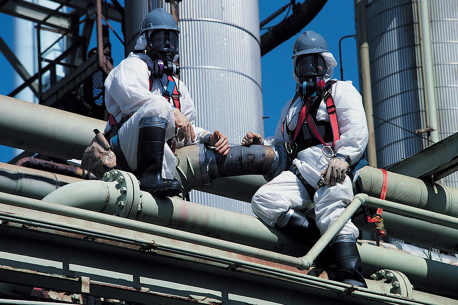 Chemical refinery, asbestos removal Photograph by Digital Vision.
