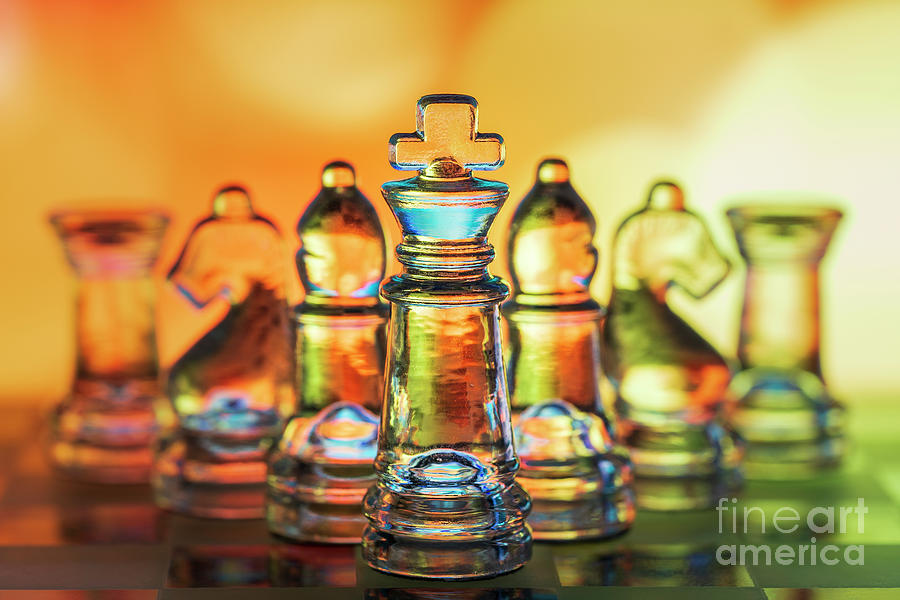 Chess figures made of glass. King in front yellow orange warm background macro Photograph by Pablo Avanzini