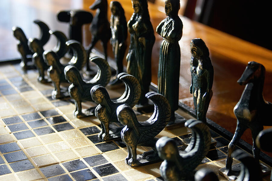 Chess pieces with brass minoan, (differential focus) Photograph by Andrew Holt