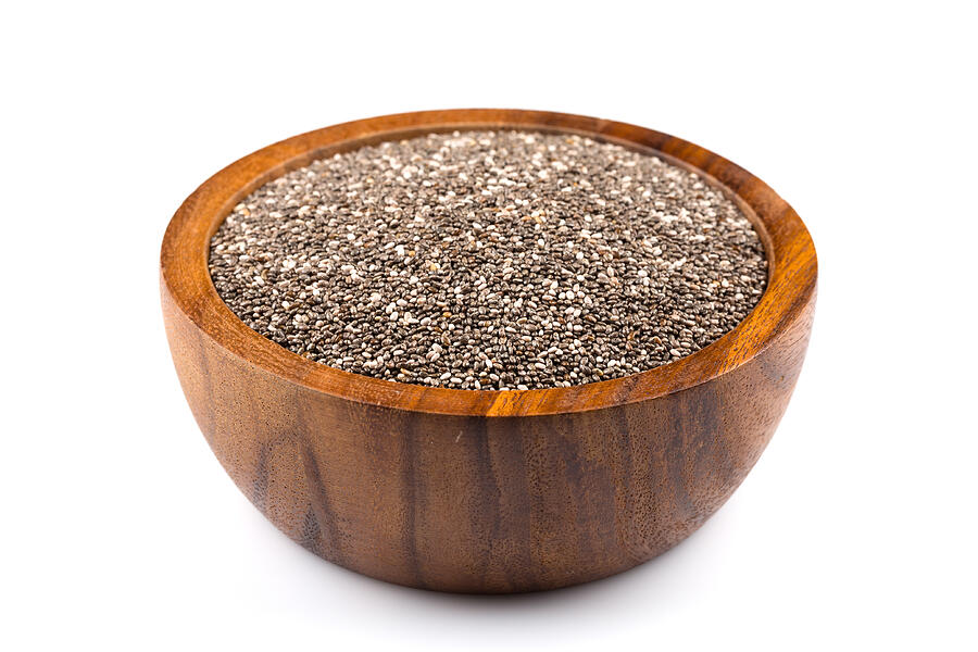 Chia seeds in wooden bowl on white background Photograph by R.Tsubin
