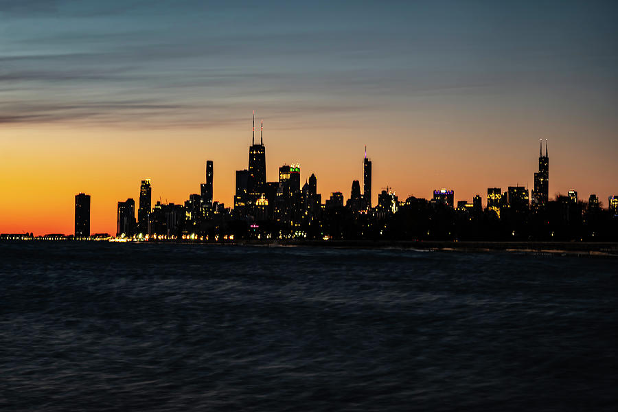 Chicago Skyline in front of an orange and purple sky Photograph by Sven Brogren