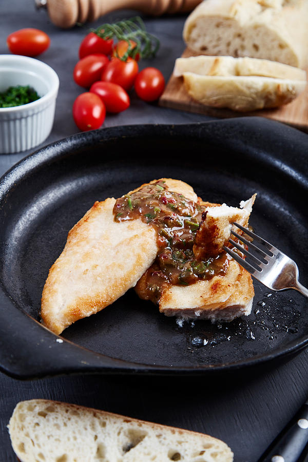 Chicken chops with sauce of cognac, broth, capers Photograph by Alexbai