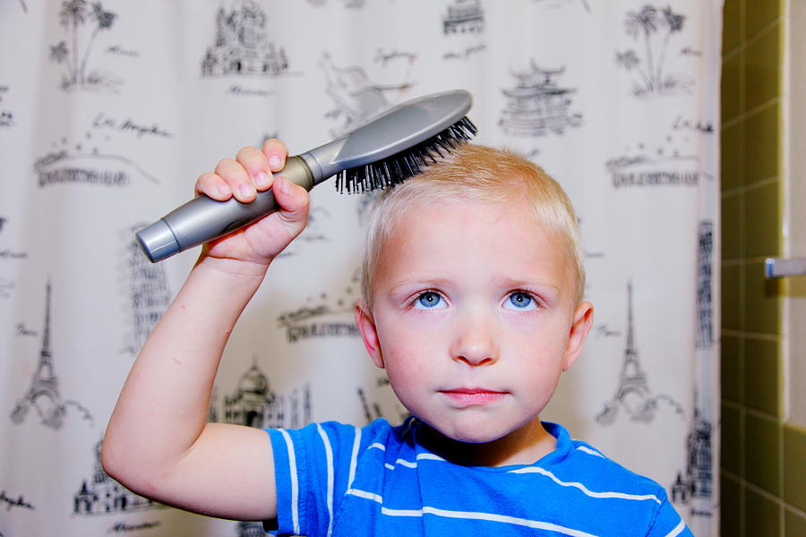 Child brushing hair Photograph by Poppy Thomas-Hill