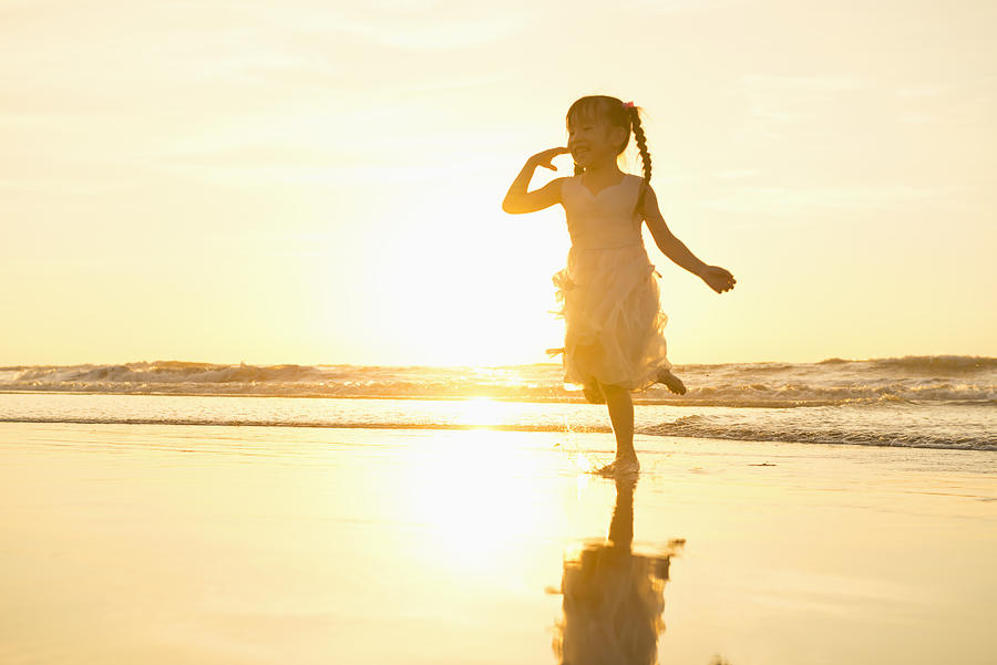 Child dancing on the beach Photograph by Leren Lu