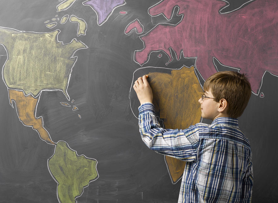 Child Drawing World Map on Blackboard Photograph by Jeffrey Coolidge