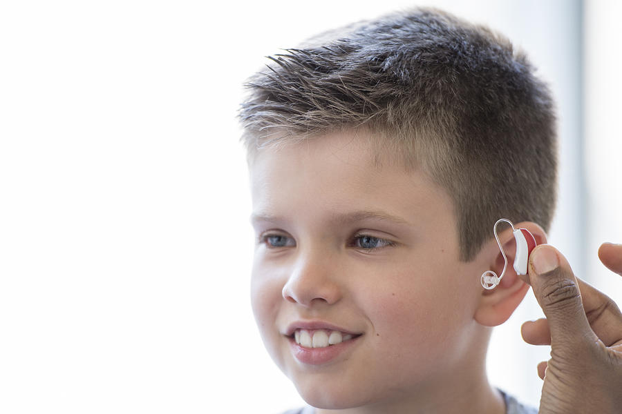 Child Getting a Hearing Aid Photograph by FatCamera