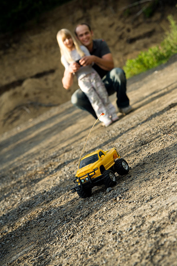Child Girl and Father Playing with Remote Car Summer Lifestyle Photograph by Snapphoto