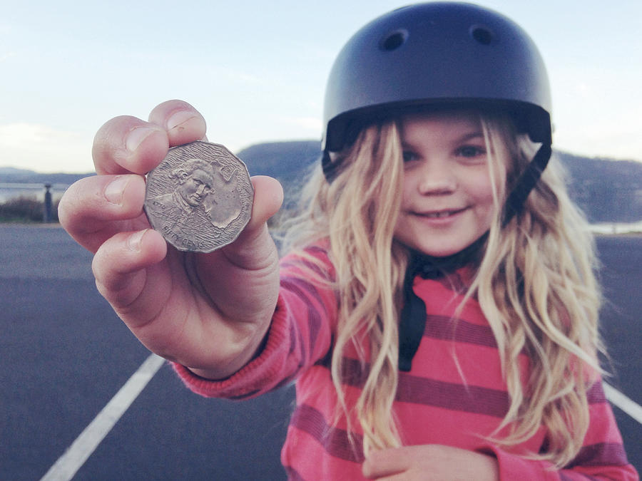 Child holding coin that she found on the ground Photograph by Jodie Griggs