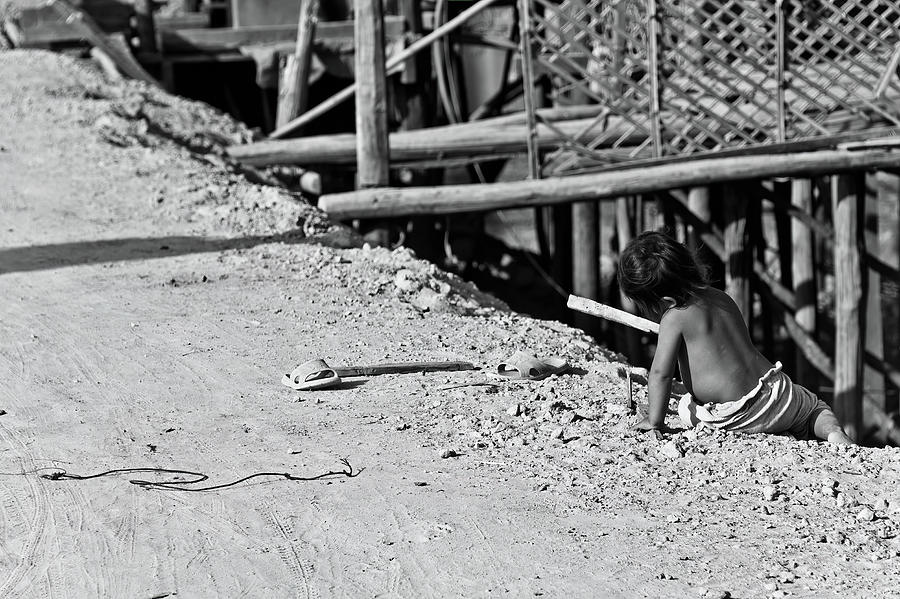 Child playing on the floor. Cambodia. Photograph by Lie Yim