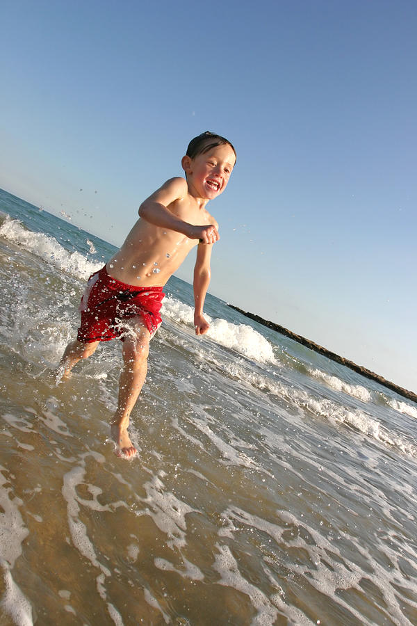 Child running in sea Photograph by Bradleym
