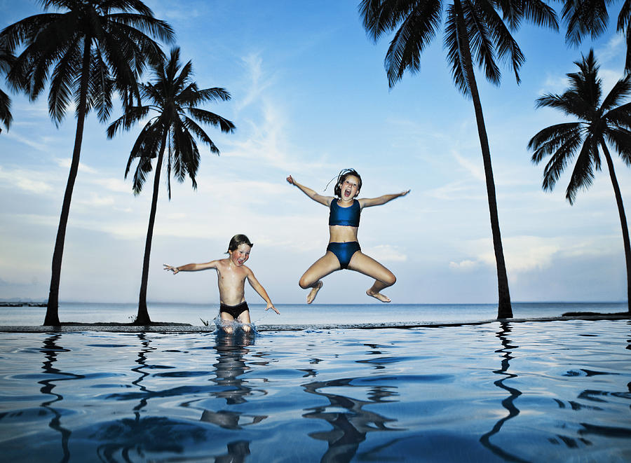 Children Jumping into Pool Photograph by David Trood