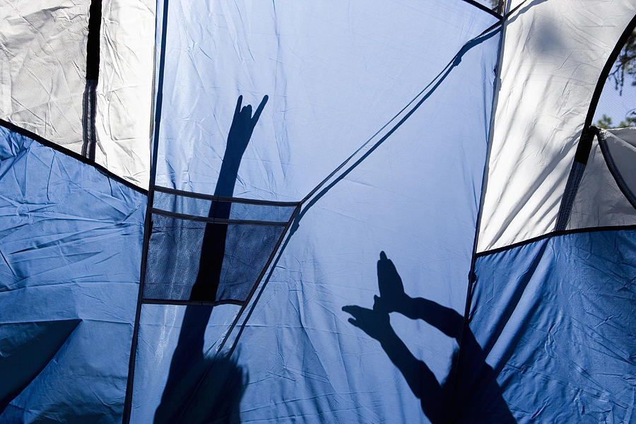 Children making shadow puppets behind a tent Photograph by Christina Kennedy