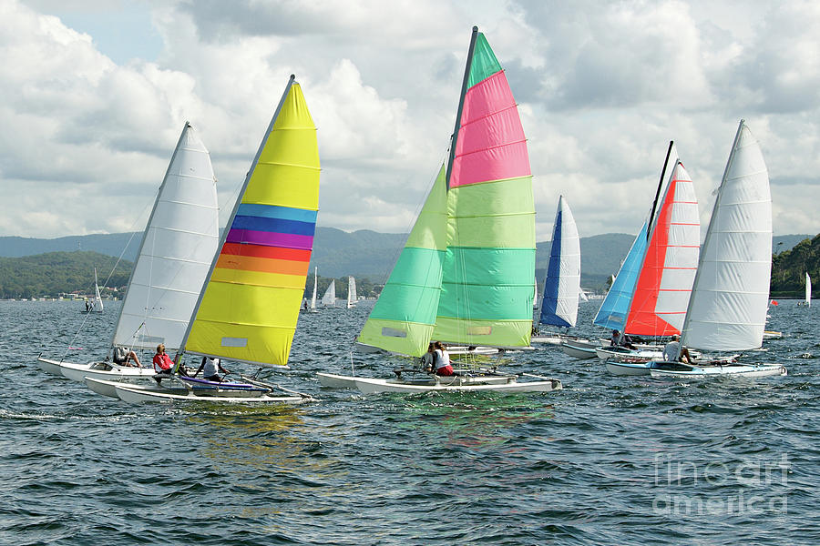 Children Sailing Small Sailboats With Colourful Sails On An Inla Photograph