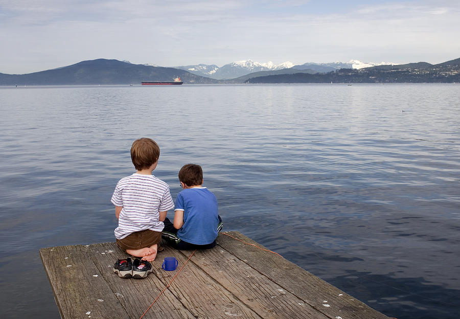Children sitting on  pier. Photograph by Jonathan Clark
