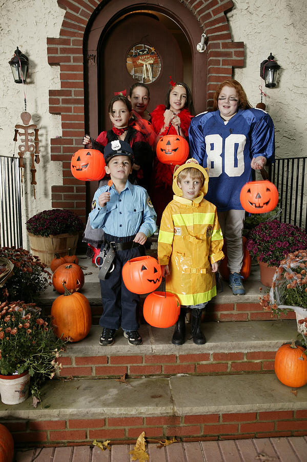 Children trick-or-treating Photograph by Comstock Images