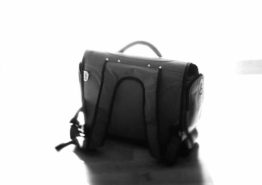 Childs school bag, b&w. Photograph by Frederic Cirou