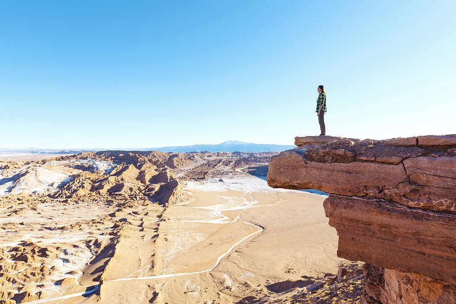 Chile, Atacama Desert, woman standing on a cliff looking at view Photograph by Westend61
