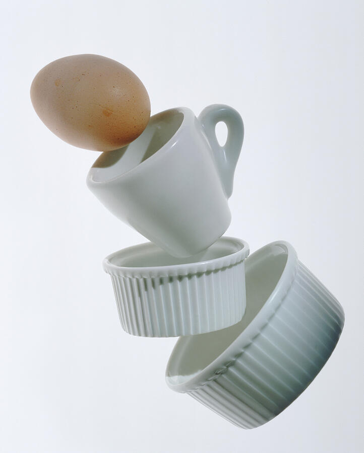 China cup and egg on white background, close-up Photograph by John Foxx