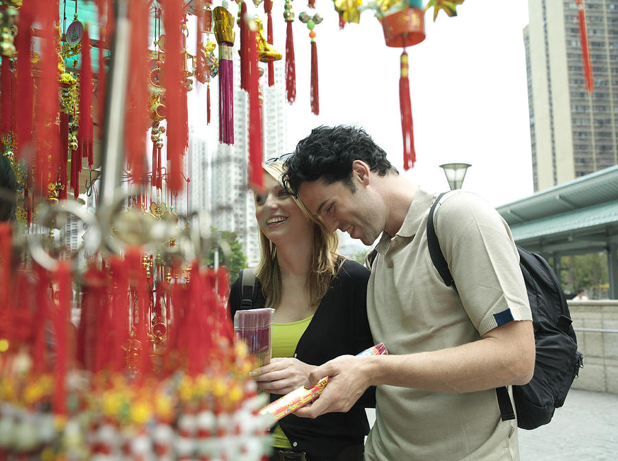 China, Hong Kong, couple looking at incense by Po Lim Temple Photograph by Eileen Bach