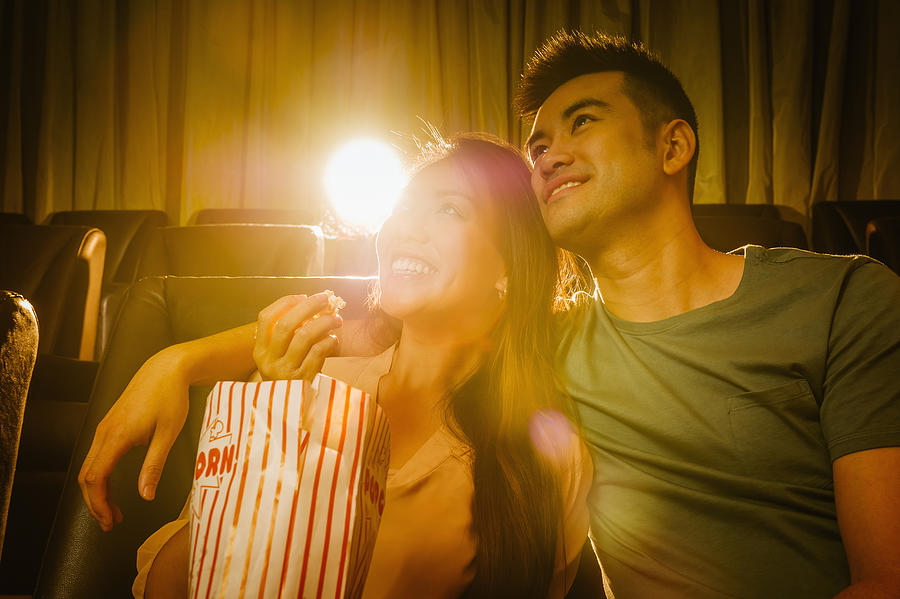 Chinese couple watching film in movie theater Photograph by Jacobs Stock Photography Ltd