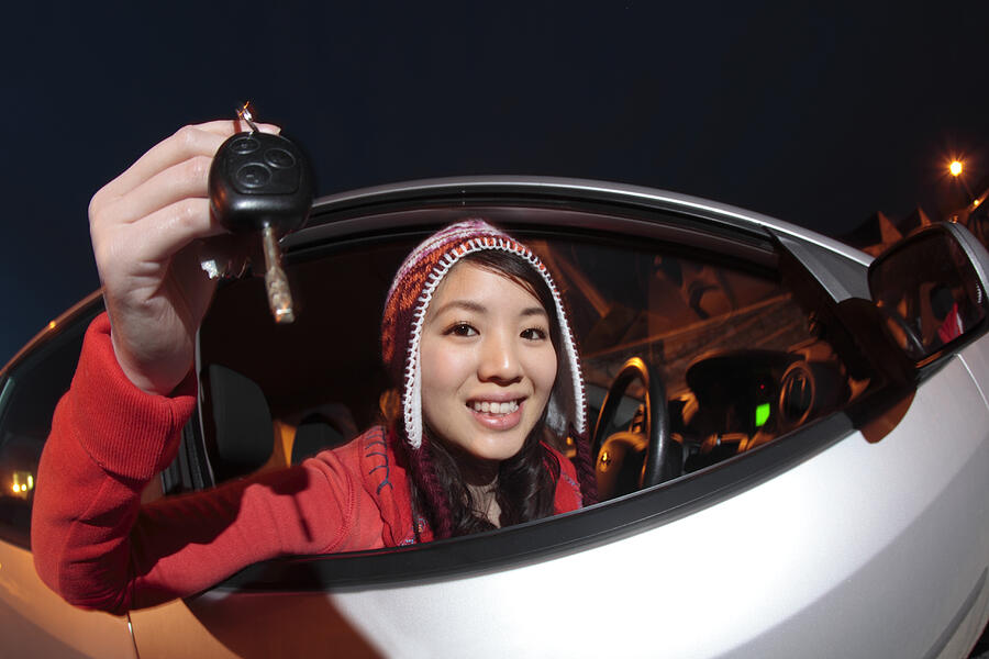Chinese Girl In Car Holding Up Keys Photograph by Peter Cade
