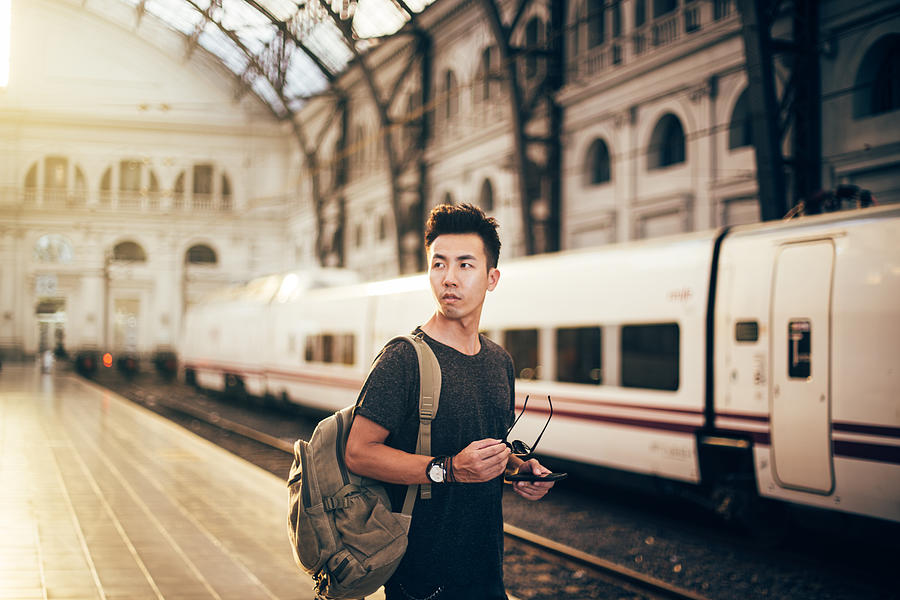 Chinese hipster man standing on station Photograph by South_agency