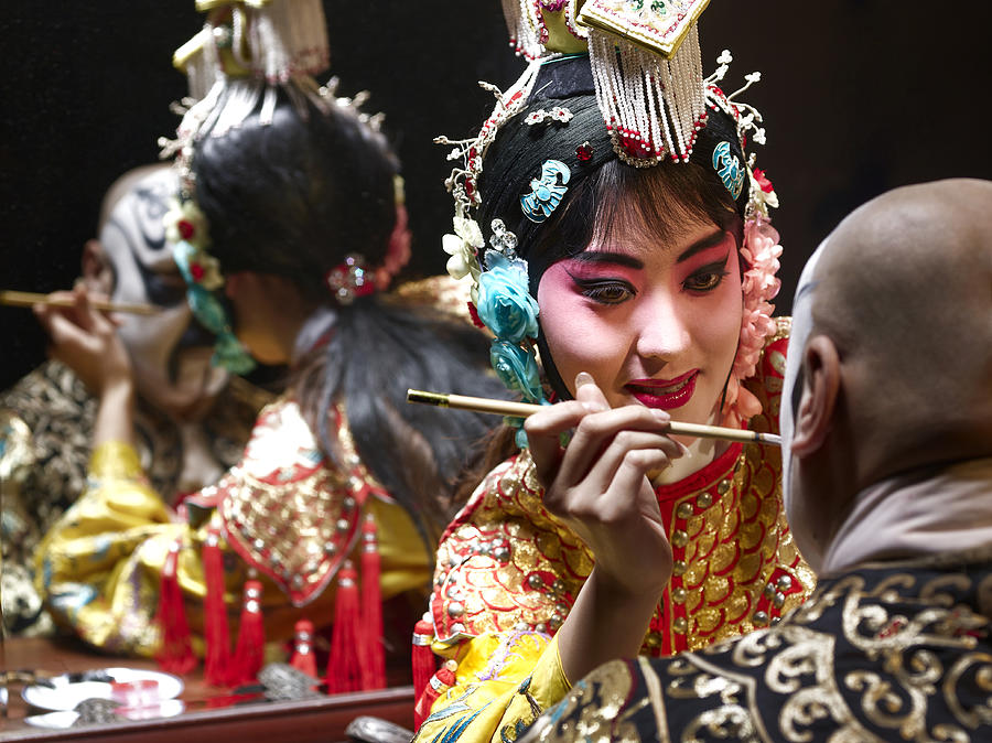 Chinese opera singer applying makeup to male Photograph by K-King Photography Media Co. Ltd
