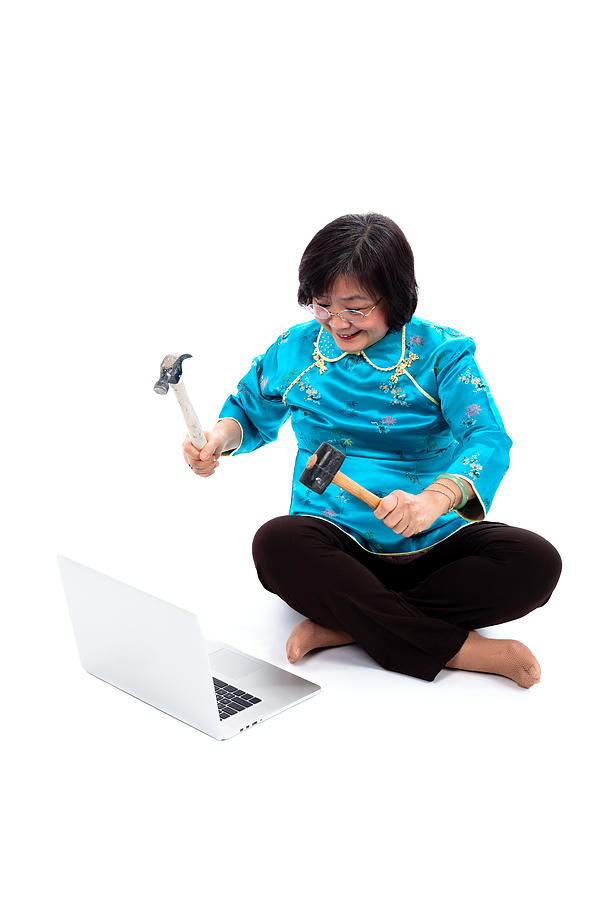 Chinese Woman ready to destroy laptop Photograph by Lambros Kazan