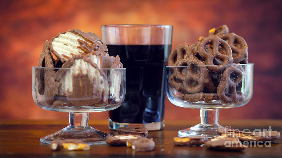 Pretzel Photograph - Chocolate covered salt and vingear potato chips and pretzels with cola drink by Milleflore Images