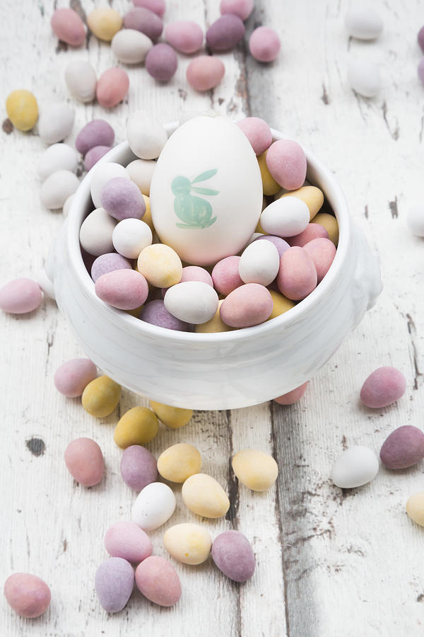 Chocolate Easter eggs and painted Easter egg in bowl Photograph by Westend61