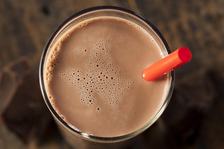 Chocolate milk on a glass with red straw Photograph by Bhofack2