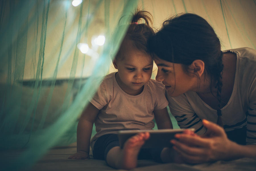 Choosing her favourite bedtime ebook Photograph by AleksandarNakic