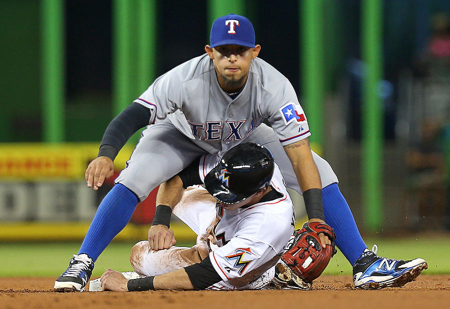 Christian Yelich and Rougned Odor Photograph by Mike Ehrmann