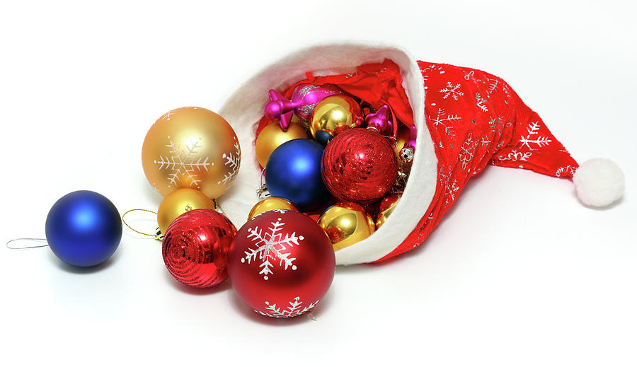 christmas balls, toys in red hat of Santa Claus Photograph by Mikhail Kokhanchikov
